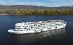 River cruise ship on a forested river
